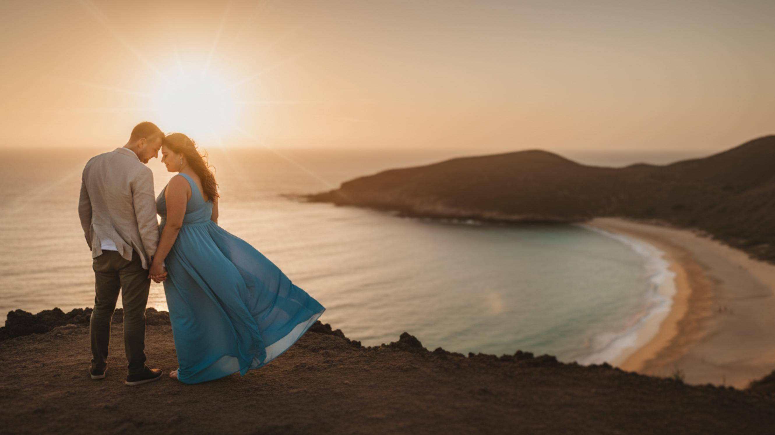 couple at golden hour on a cliffside on their honeymoon funded by honeyfund
